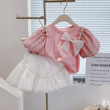 Girls Modern Princess 2Pc Puff Sleeve Top & Puff Skirt Set. Adorned With Bow and Streamer Pearl Shoulder accents.