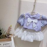 Girls Modern Princess 2Pc Puff Sleeve Top & Puff Skirt Set. Adorned With Bow and Streamer Pearl Shoulder accents.